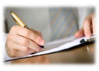 A stock image of a person signing a paper.